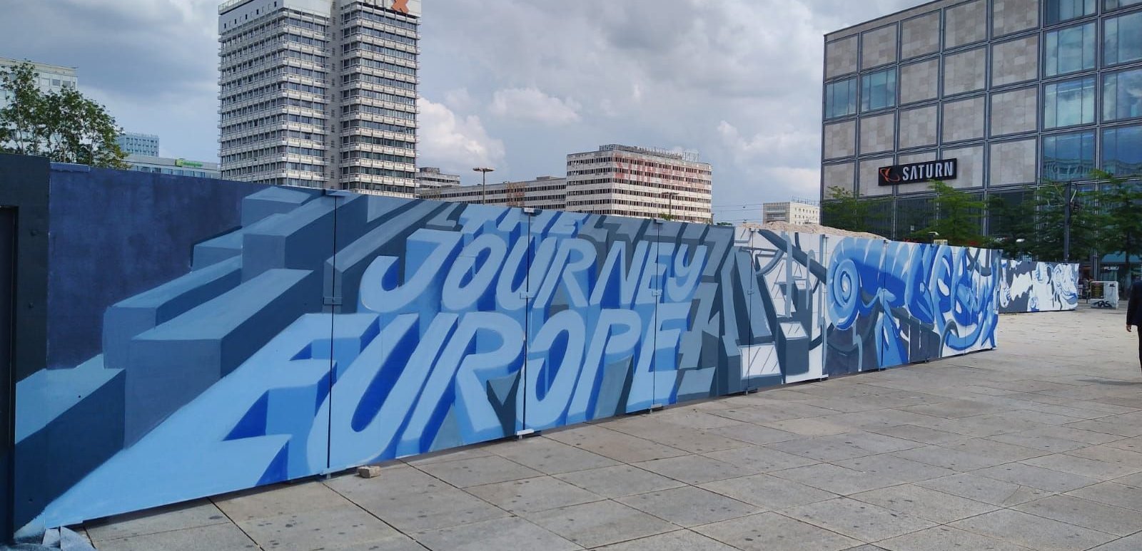 modernes Wandgemälde mit Hochhaus im Hintergrund