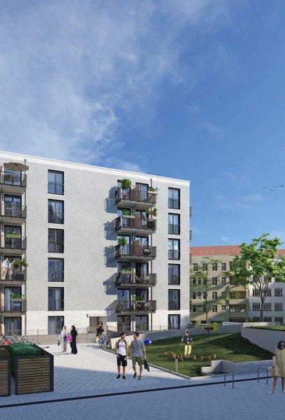 Fassade Mehrfamilienhaus mit Grünflächen und Tiefgarageneinfahrt