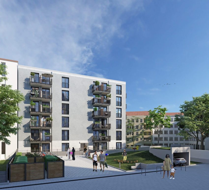 Fassade Mehrfamilienhaus mit Grünflächen und Tiefgarageneinfahrt